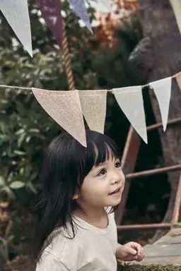 Kid under hanging flags