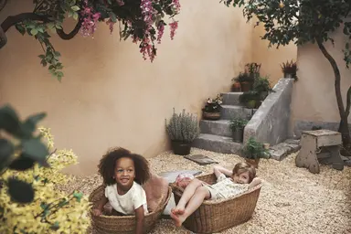 Kids sitting in baskets