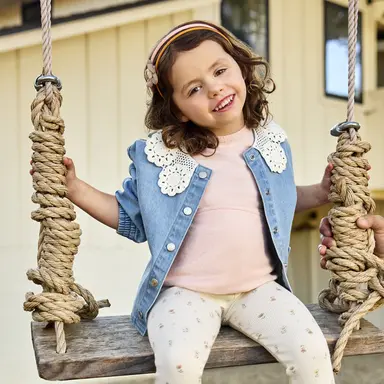 Girl in comfy clothes on a swing
