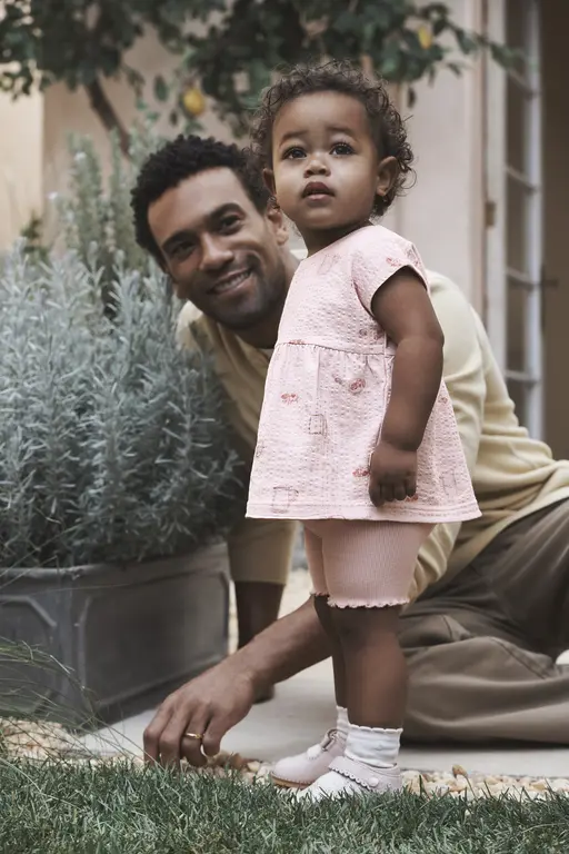 Girl standing next to dad