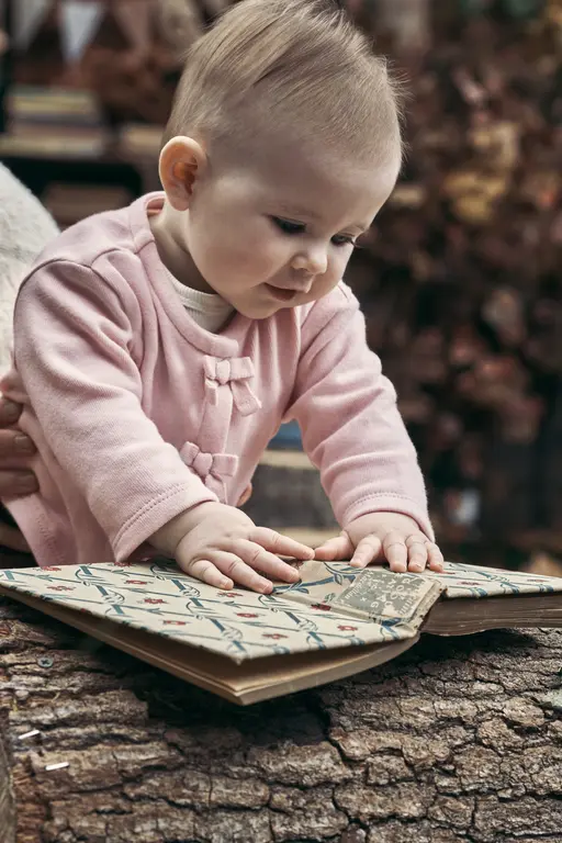 Baby touching book