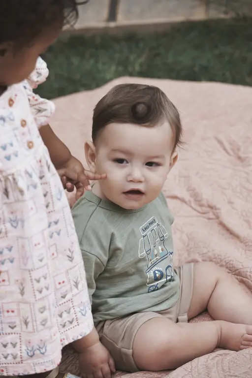 Kids sitting on blanket