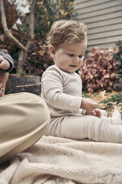 Baby playing with leaf
