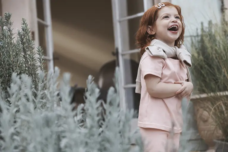 Girl standing outside laughing 