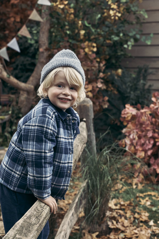 Boy standing on fence