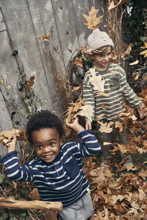 Boys playing in leaves