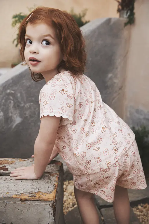 Girl standing next to rock