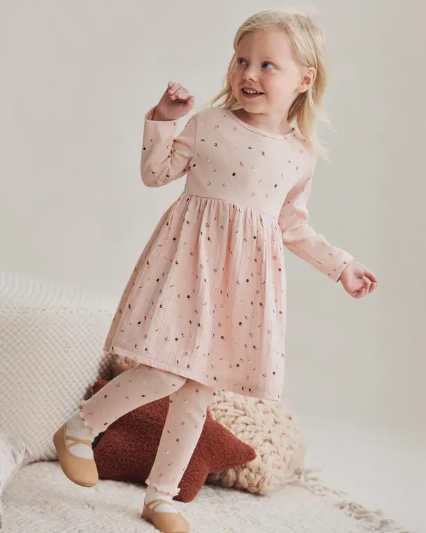 Girl wearing pink dress and matching tights