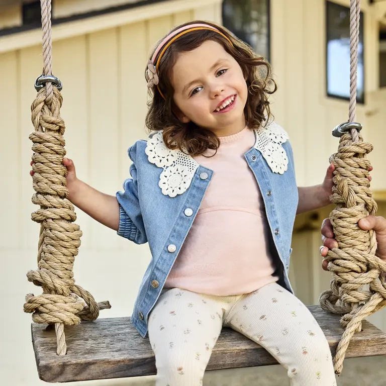 Girl in comfy clothes on a swing
