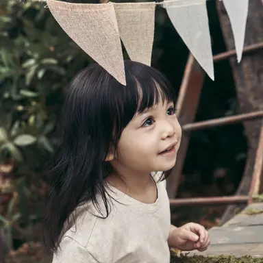 Kid under hanging flags