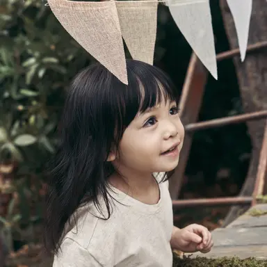 Kid under hanging flags