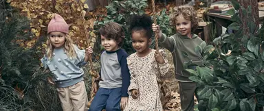 Children together on a swing in woods