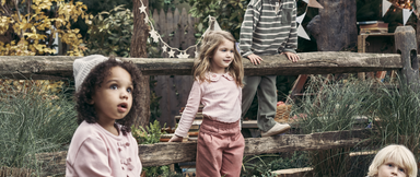 Kids standing on fence