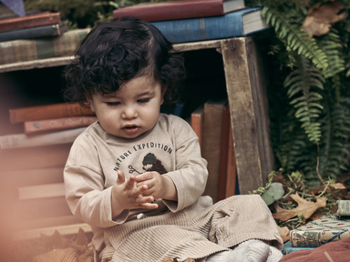 Baby in front of books