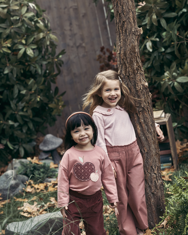 Girls standing by tree