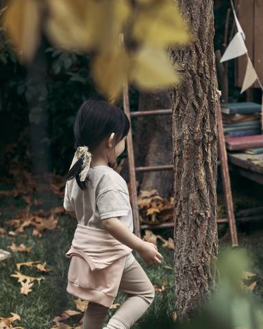 Girls standing by tree