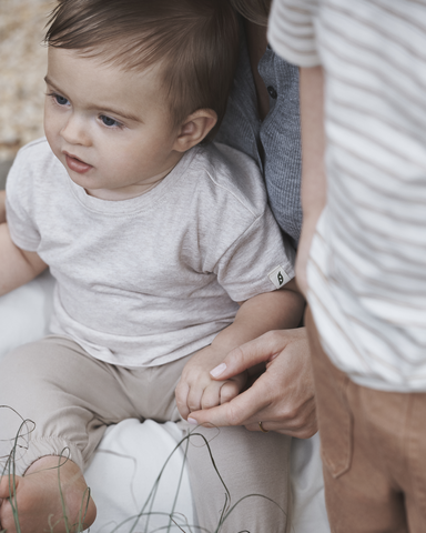baby sitting in parents lap