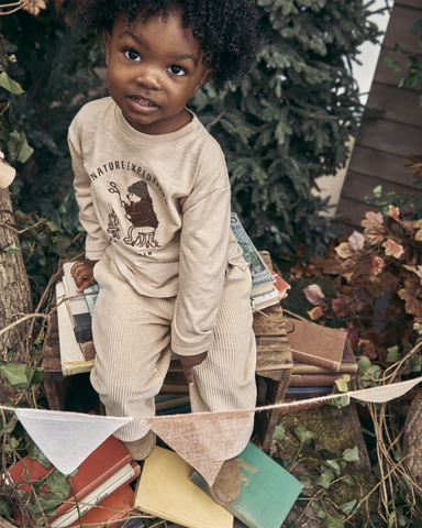 Boy sitting on books