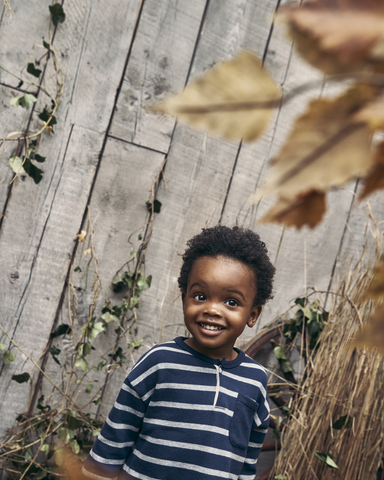Boy smiling by fence